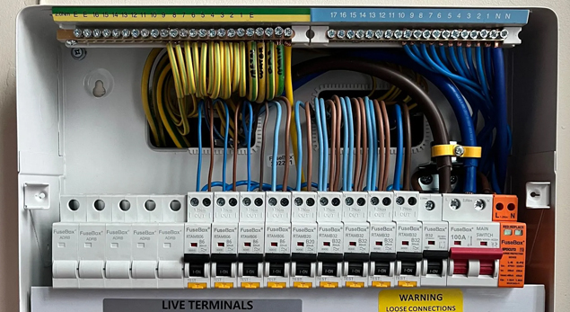 An electrician explaining a modern electrical system to a homeowner.