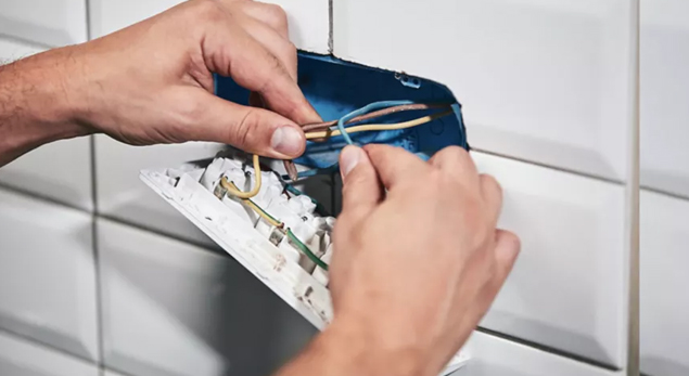 An electrician reviewing Part P compliance documentation.